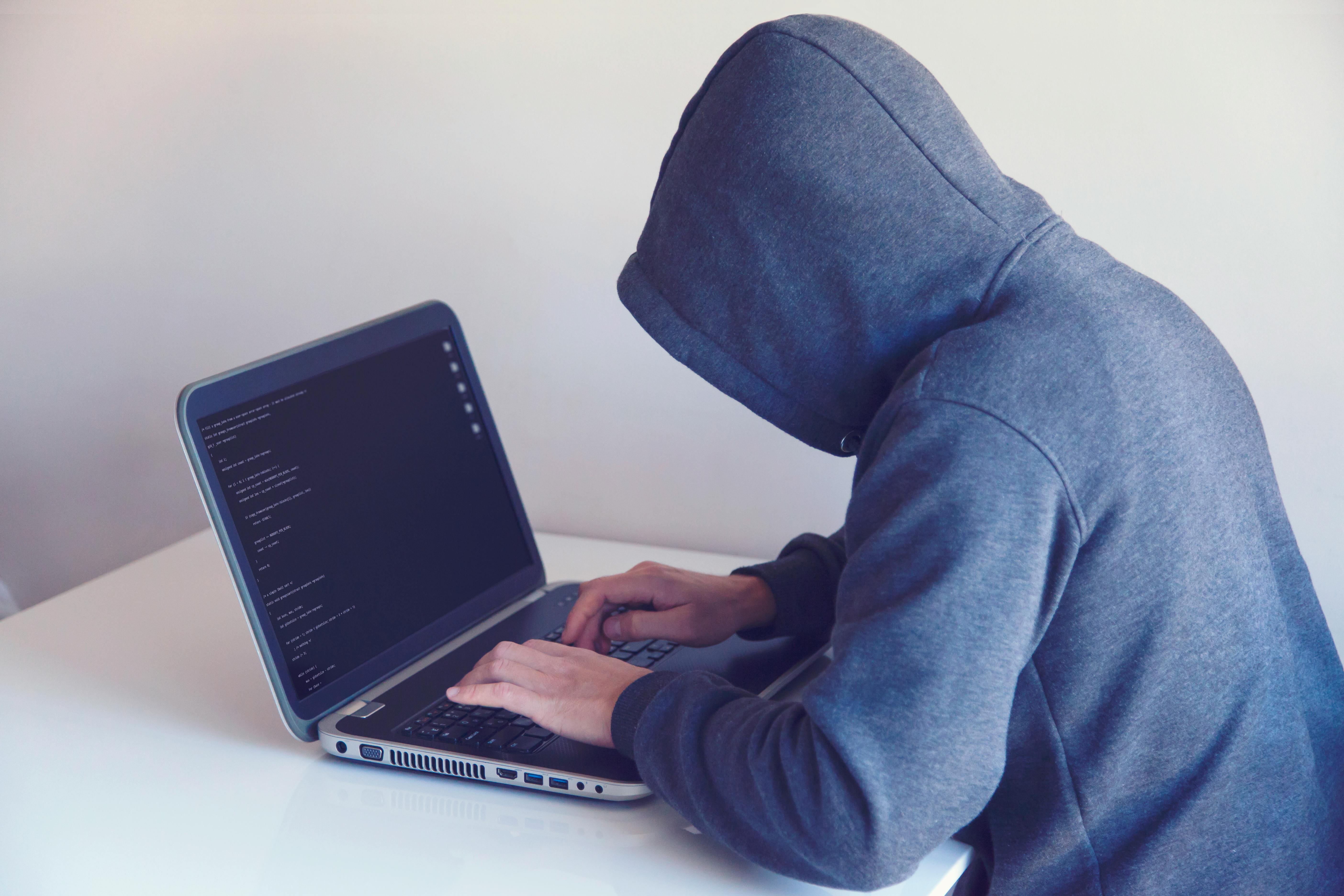 Cyber attacker using computer to carry out a cyber attack